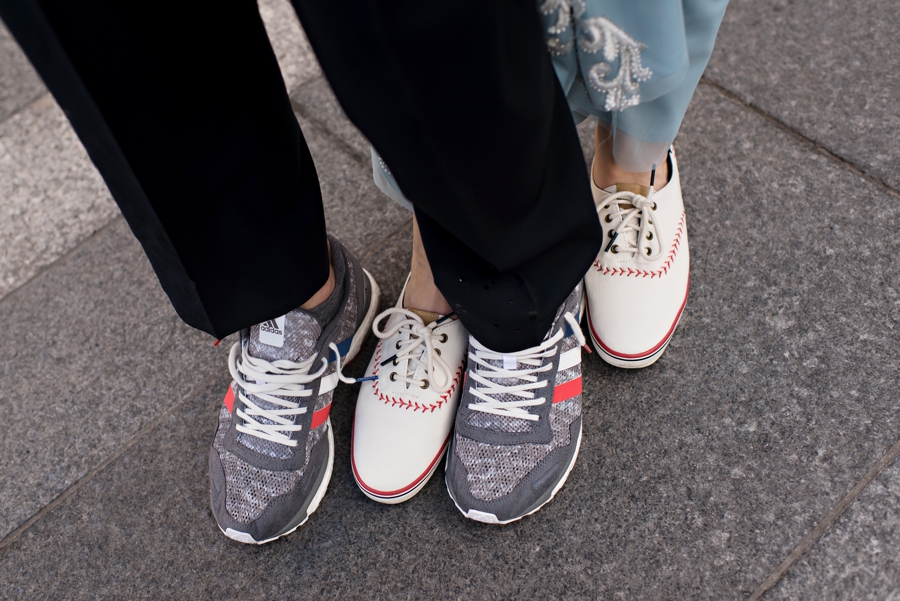 A wedding couple switch to baseball sneakers before a Phillies game.